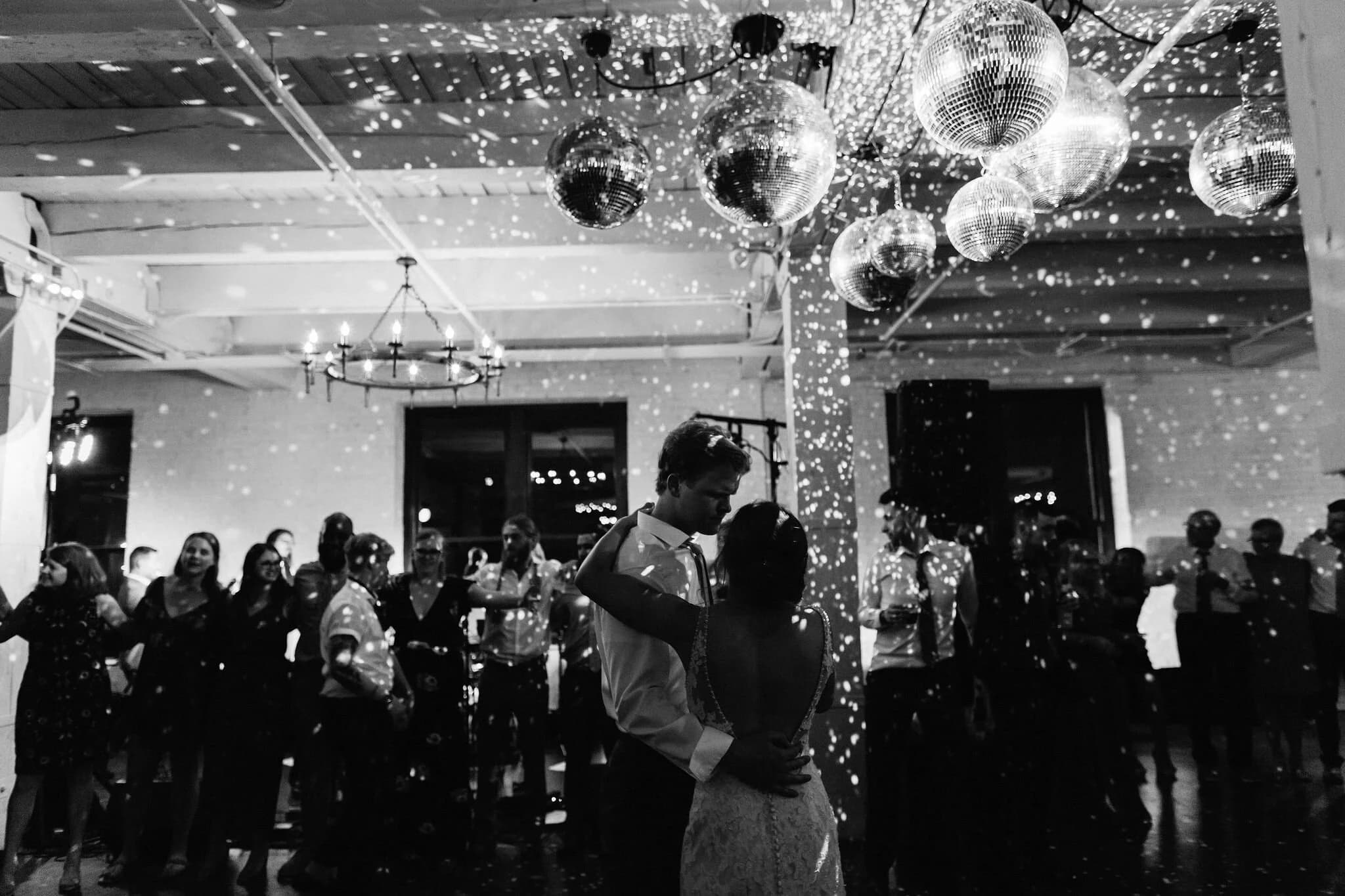 Newlyweds dancing under disco balls at The Poppy Estate